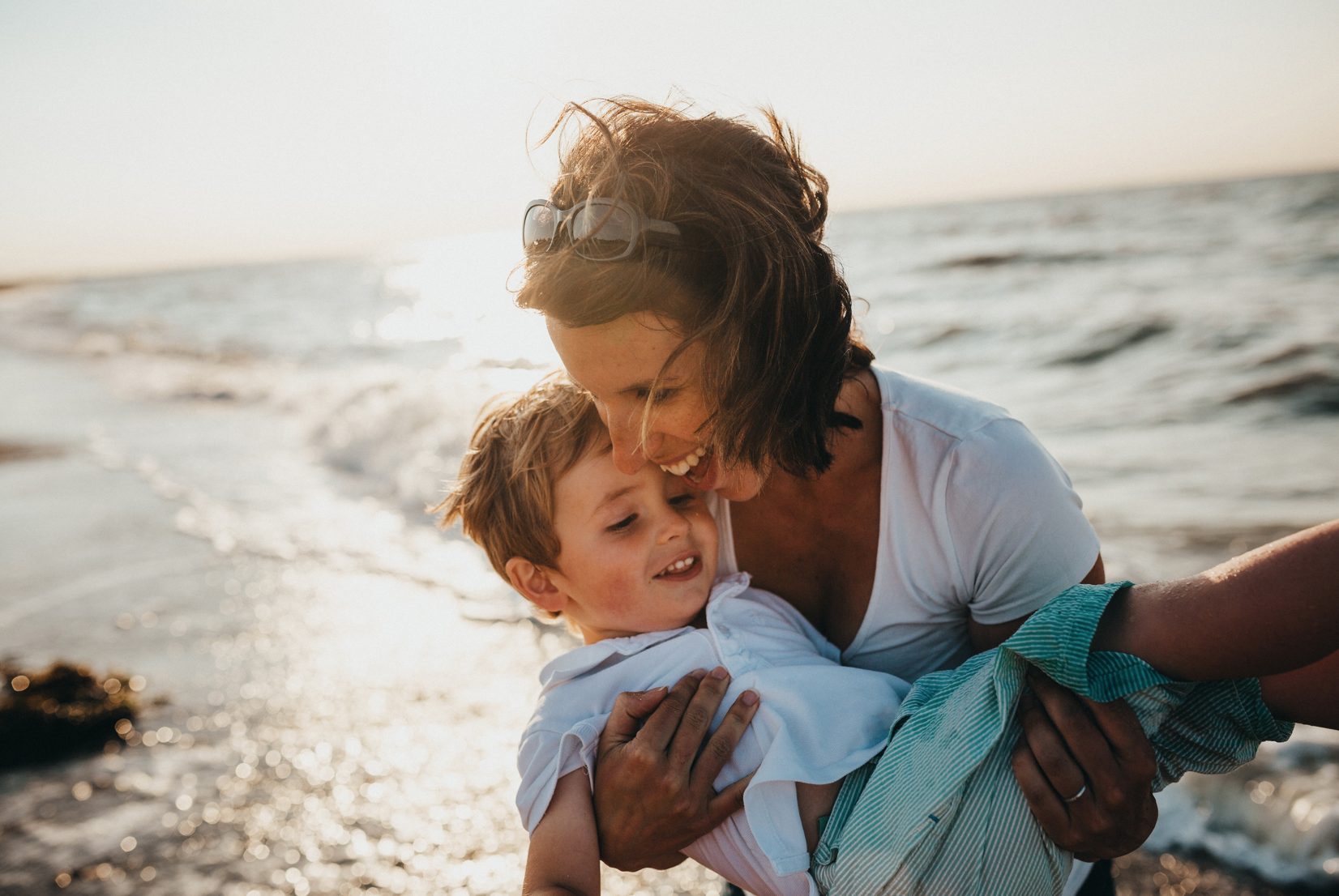 Woman and child playing at the beach