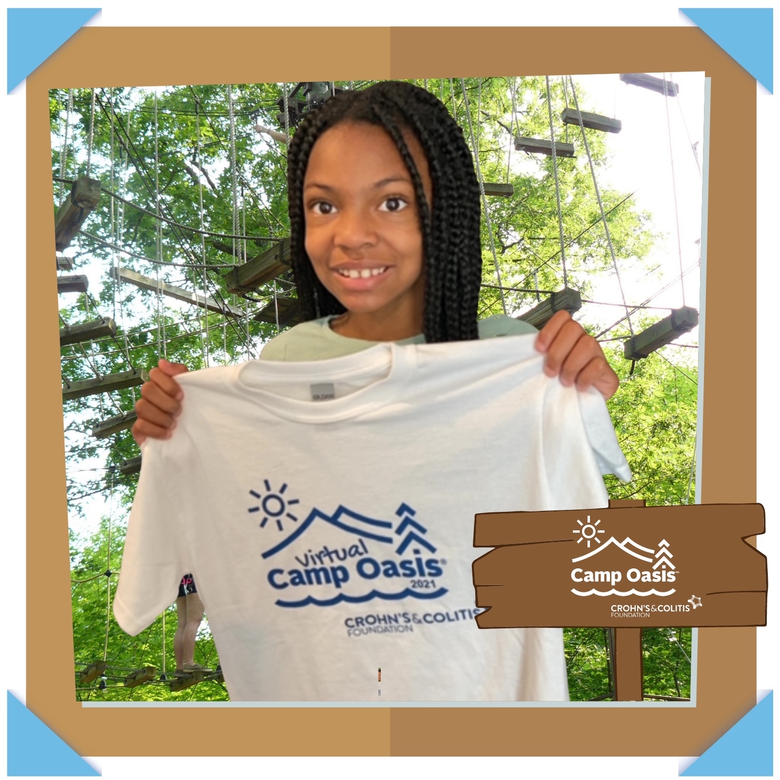 Camp Oasis camper holding up t-shirt