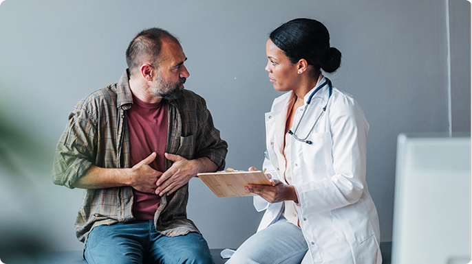 Middle aged man speaking with his doctor and learning about IBD