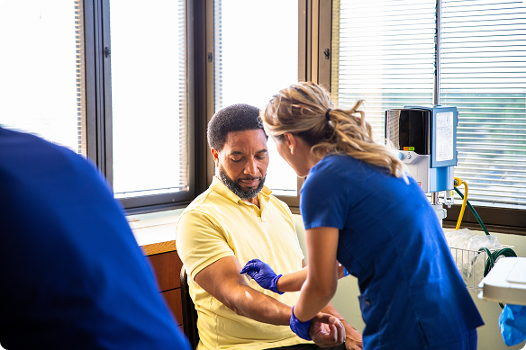 Man being swabbed by female nurse for blood test.