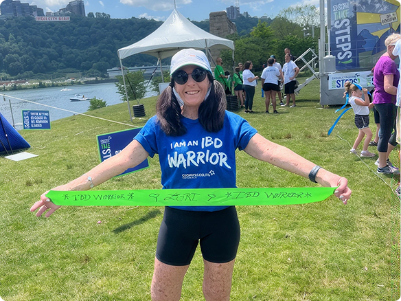 Woman at a busy Take Steps event wearing an ‘I am am IBD Warrior’ t-short