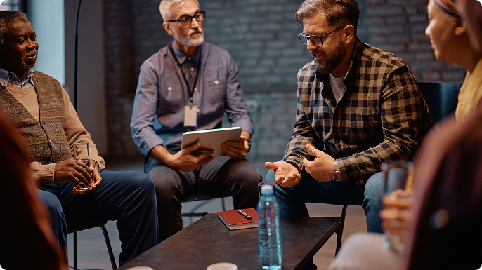 Group of adults converse at a support group.