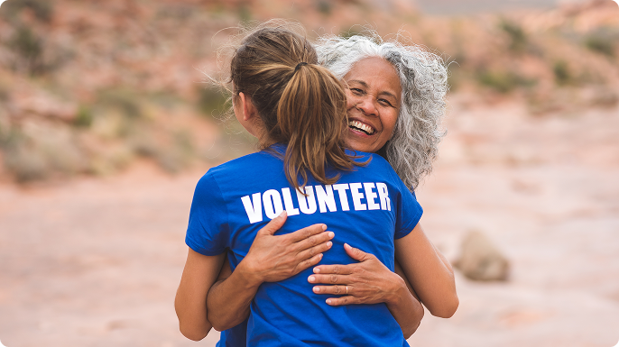 A woman hugs a female volunteer.
