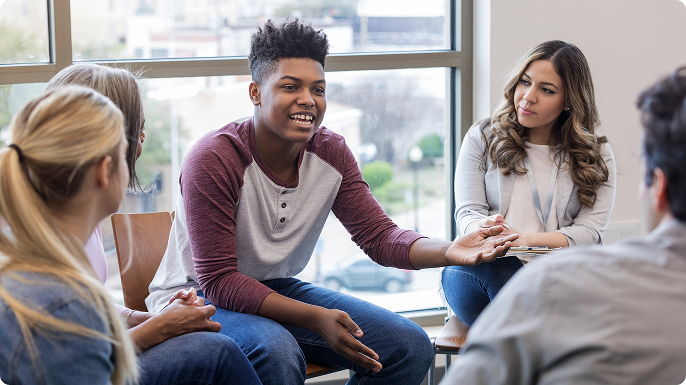 Group of teens converse at support group.
