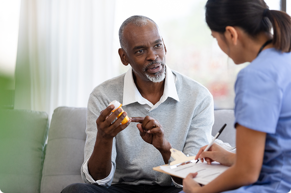 Man discusses his medication with a nurse.