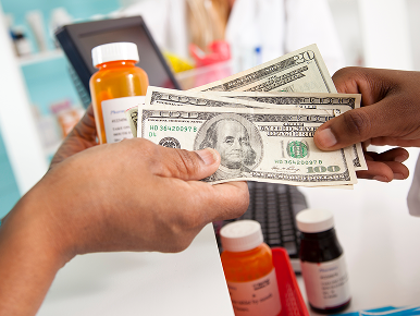 Handing a lot of money over to receive medication at pharmacy.