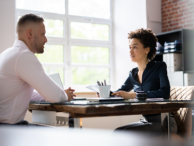 Man discussing workplace accommodations with female HR director.