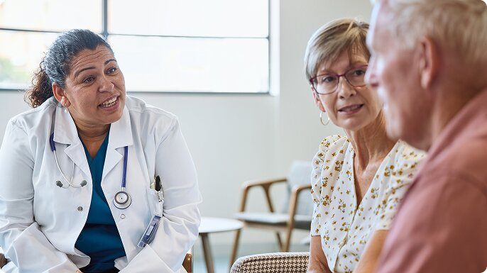 An older couple discusses treatment with their doctor.
