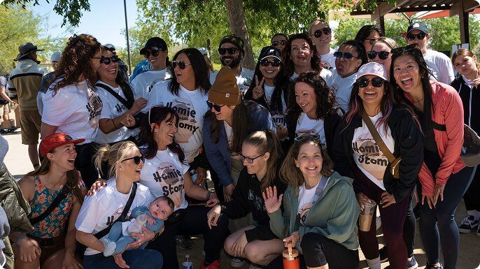 A large group of men and women supporting their friend at a Crohn’s & Colitis event