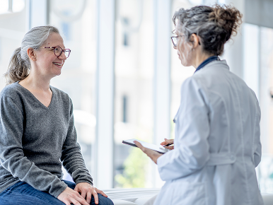 A woman discusses her condition with her female doctor