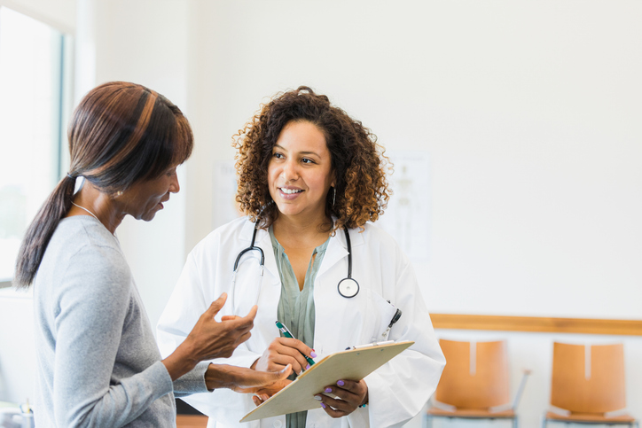 Healthcare provider discussing treatment options with a patient, demonstrating supportive patient–doctor communication in a modern medical office