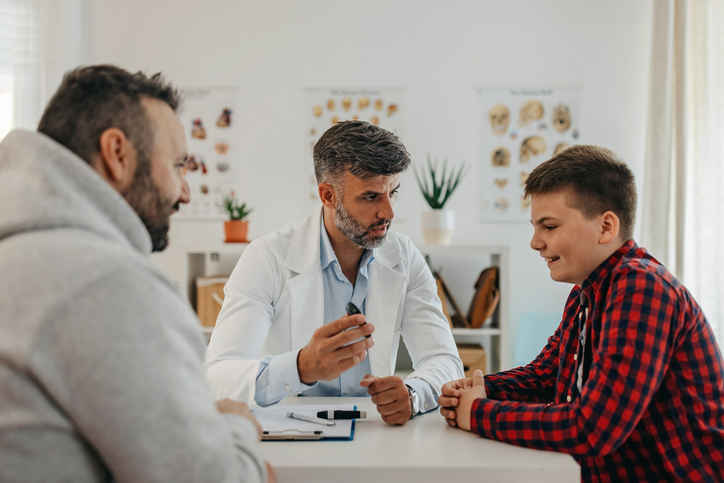 Doctor, parent, and adolescent engaging in shared decision-making