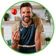 Man holding apple in kitchen