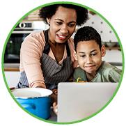 Mother and son reviewing recipes on their laptop