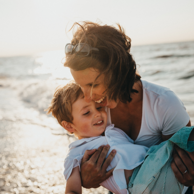 Woman and child playing at the beach