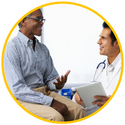 Doctor speaking with patient, both male adults