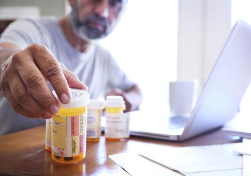 Person organizing Crohn’s disease and ulcerative colitis medications at home