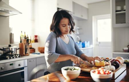 Person preparing a nutrient-rich meal while managing IBD