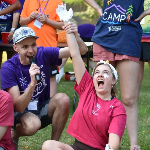 Camp Oasis, camper lifting their hand up