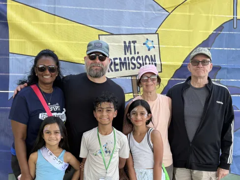 Family in front of banner that says Mt. Remission