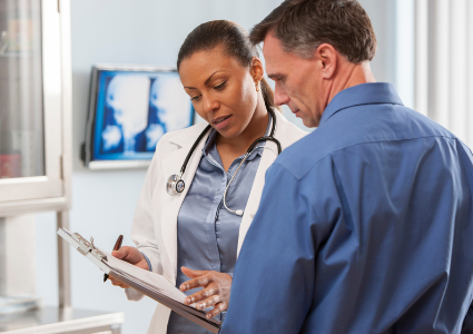 Patient and doctor looking at a clipboard together