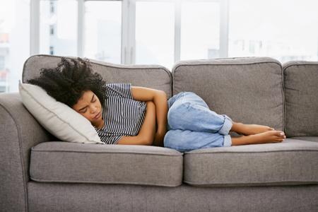 Person experiencing abdominal pain related to Crohn’s disease or ulcerative colitis symptoms”