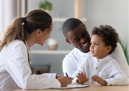 Father and son visiting pediatrician