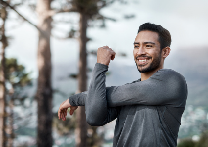 Latinx man stretching outdoors