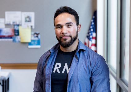 Veteran standing in office wearing ARMY shirt