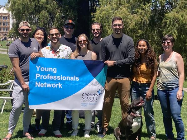A group of smiling people holding a sign that says Young Professionals Network