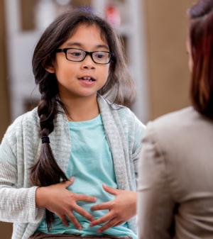 Girl discussing condition with doctor