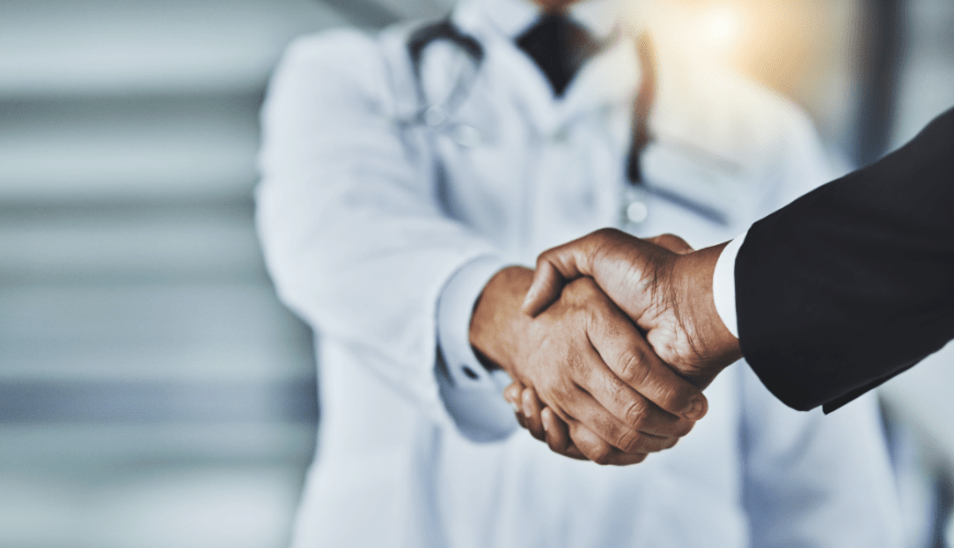 a doctor and an industry professional shaking hands